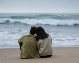 Beach couple snuggled